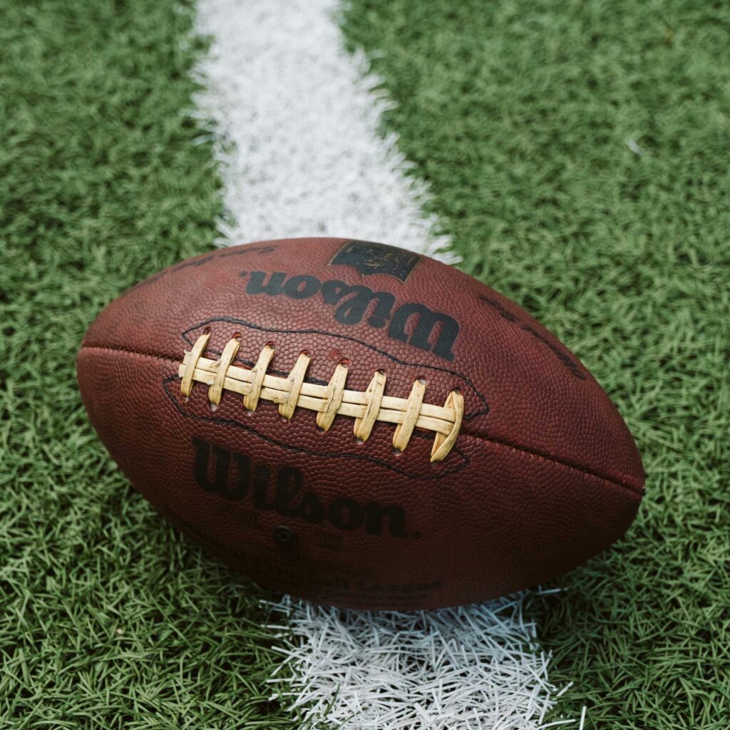Close up of a football on the line of scrimmage.
