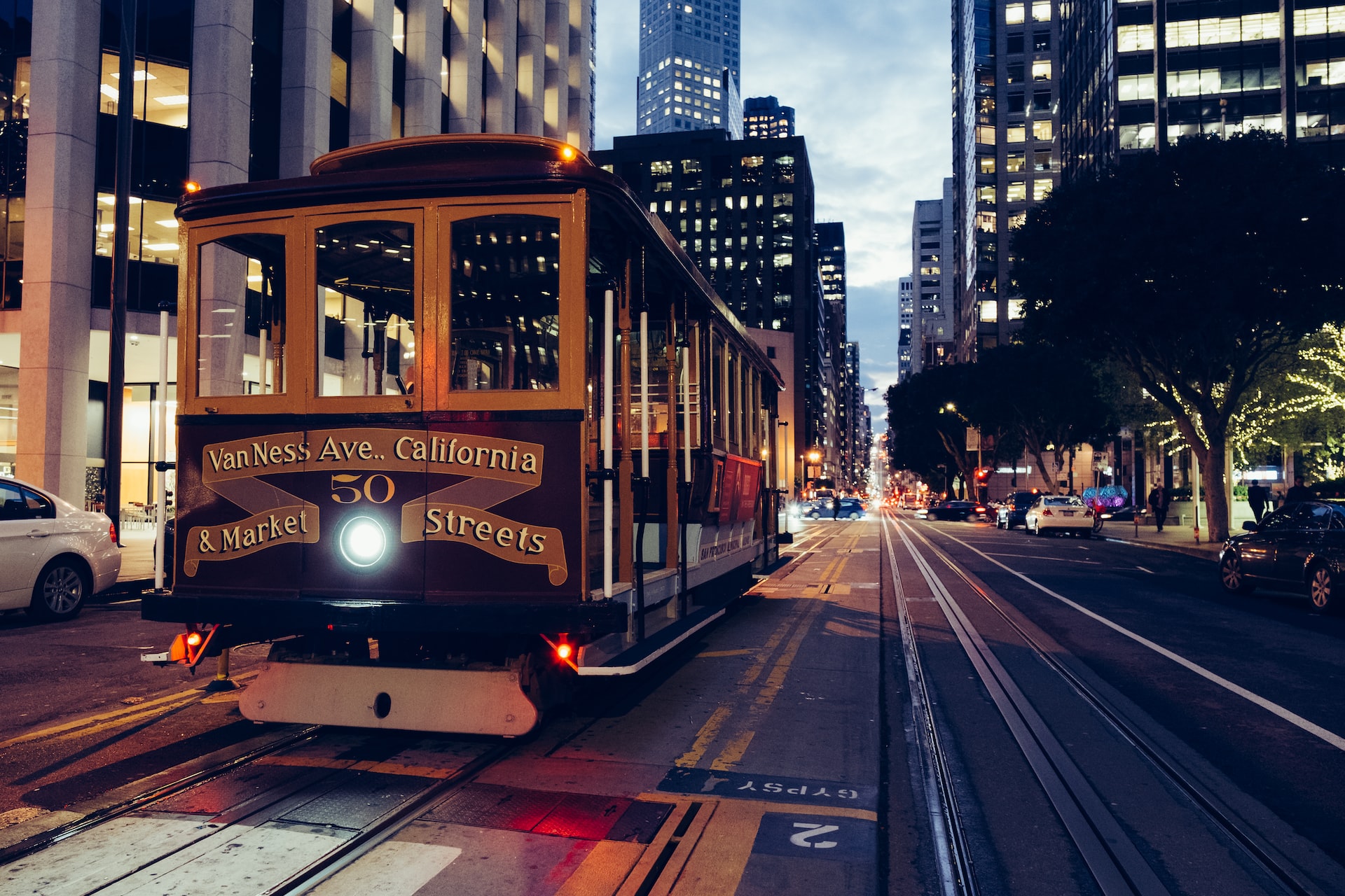 Streetcar trolley traveling down the streets of San Francisco at dusk.